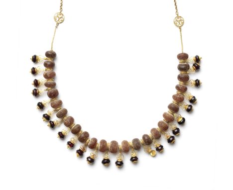  A Roman amber and garnet bead necklace  Circa 1st-2nd Century A.D. and laterThe amber beads of spherical form interspersed w