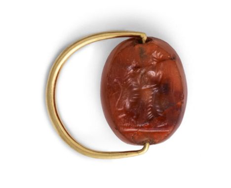  A Graeco-Persian carnelian scaraboid Circa 5th-4th Century B.C.Engraved on the underside with a Persian king in combat with 