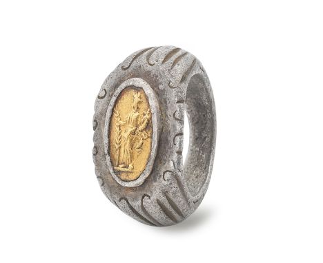  A Roman silver and gold ring  Circa 2nd-3rd Century A.D.The solid angular shouldered and ridged hoop, formed into a large ov