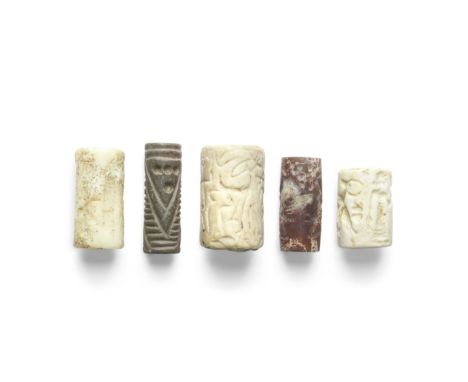  Five Near Eastern cylinder seals Circa 3rd-1st Millennium B.C.Comprising a Mitanni white stone seal with animals and a figur