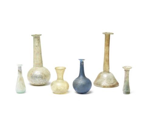  Six Roman glass flasks 1st-5th Century A.D.A blue glass bottle with trail decoration, 11cm high; a candlestick unguentarium,