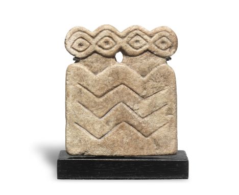  A Mesopotamian marble double 'eye' idol Tell Brak Region, circa 3500-3300 B.C.The plaque incised with two pairs of eyes, the