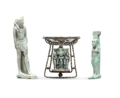  Three Egyptian glazed faience amulets Late Period, circa 664-332 B.C.Including a triad amulet plaque of Harpocrates wearing 