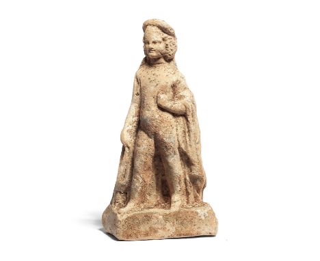  A Greek terracotta figure of a young boy  Boeotia, late 4th Century B.C.The plump young child stepping forth with his right 