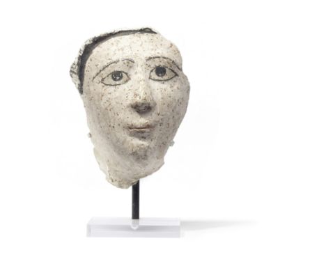  A Romano-Egyptian stucco mask of a young woman Circa 2nd Century A.D.The eyelashes and eyebrows delicately painted in black,