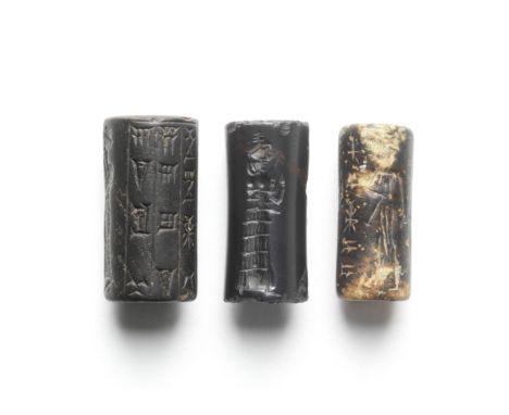  Three Old Babylonian cylinder seals Circa 2300-1150 B.C.One Akkadian seal of mottled black and brown stone, with worshippers