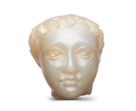  A Roman chalcedony head of a boy Circa 1st-2nd Century A.D.With thick wavy curls, swept forward into a fringe the large eyes