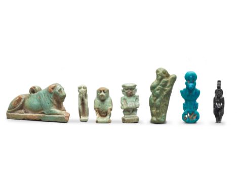  Seven Egyptian glazed faience amulets Late Period-Ptolemaic, circa 664-30 B.C.Including a large lion amulet, the mane with i