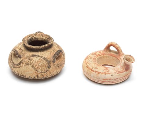  Two Mycenaean pottery vessels Circa 1500-1100 B.C.A squat alabastron with three arched handles at the shoulder, decorated in