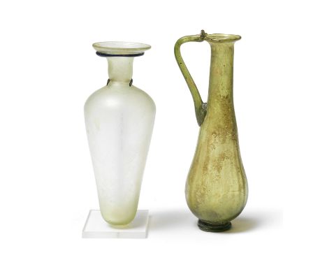  Two Roman glass vessels  Circa 4th-5th Century A.D.A pale green glass flask, with piriform body, tapering to the base, a ban