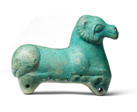  A blue glazed ceramic figure of a ram North West Iran, circa 8th Century B.C.The recumbent ram with curved notched horns and