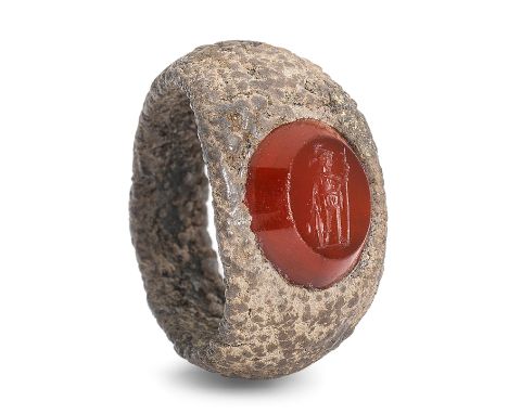  A Roman iron and carnelian intaglio ring with Mars Circa 1st-2nd Century A.D.The gem set in the iron ring, the god depicted 