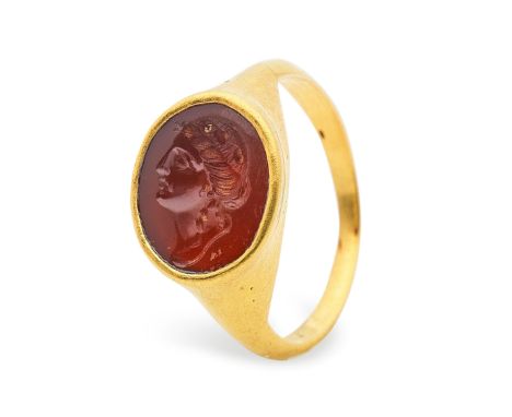  A Roman gold and carnelian intaglio ring with the head of a woman Circa 1st-2nd Century A.D.Engraved with the profile head o