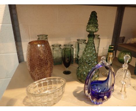 Shelf of mixed glassware including blue green and red 