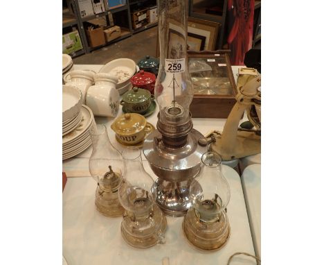 One chrome plated oil lamp and three small glass oil lamps with handles
