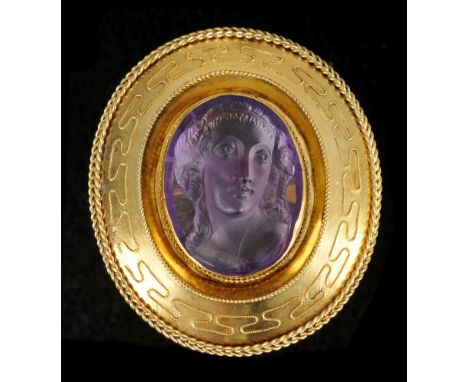 An Amethyst Cameo Brooch the oval stone carved bust of a girl in wide frame with applied rope twist decoration