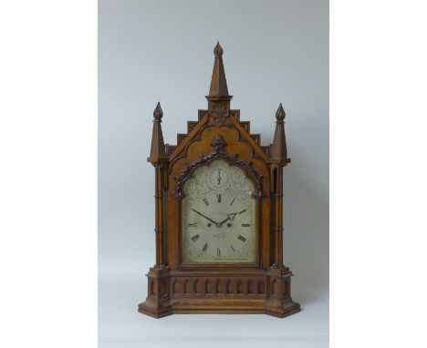 A Victorian oak gothic style Bracket Clock with arched top above a silvered dial inscribed Thos. Penlington, Liverpool, strik