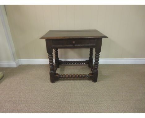 A late 17th Century oak Side Table fitted frieze drawer on bobbin turned and square supports and stretchers, 2ft 6in