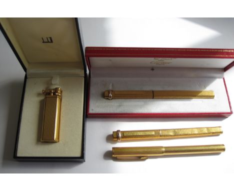 A gold plated Dunhill Lighter, a les must de Cartier Fountain Pen with textured gold plated case with matching Propelling Pen