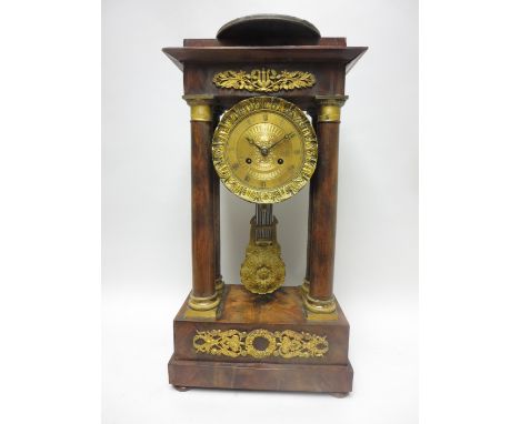 A 19th Century French Empire Mantel Clock with engraved brass circular dial, two train movement, in mahogany case having four