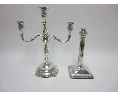 A Dutch silver two branch Candelabrum on shaped circular base, 12in, and a single sterling Candlestick with fluted column on 