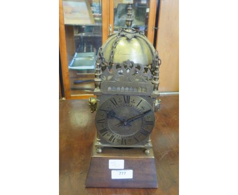 A brass Skeleton Clock with domed top, named after Thomas Knifton in Lothenbury, on a wooden stand, 11 1/2 in H 