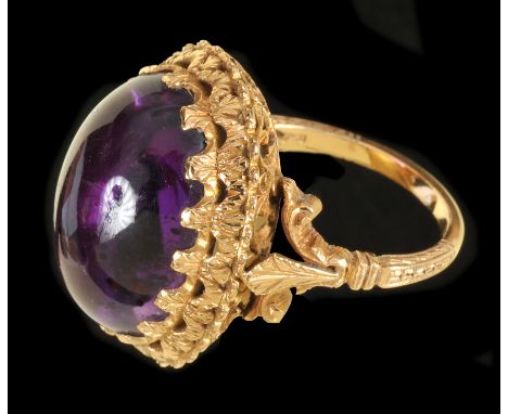 An Amethyst Ring claw-set large cabochon in intricate pierced mount, stamped 750, ring size O