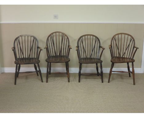 A matched set of four 19th Century Windsor Elbow Chairs with stick backs and turned supports and stretchers