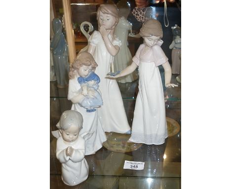 Lladro praying angel child, and three Nao figures