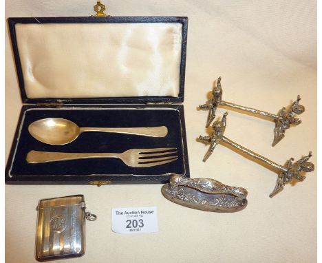 Silver vesta case, child's cased cutlery set, nail buffer - all hallmarked. Together with silver-plated knife rests in the fo