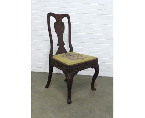 An unusual side chair with figural carved splat and tapestry upholstered seat over a frieze with mythical animals, on mask he