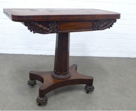 An early 19th century rosewood games / card table, the fold over top with rounded corners and a felt lined interior, the frie