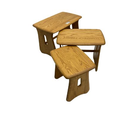 Ercol - elm 'Windsor' nest of three occasional tables, rectangular top on shaped and pierced end supportsDimensions: Height:&
