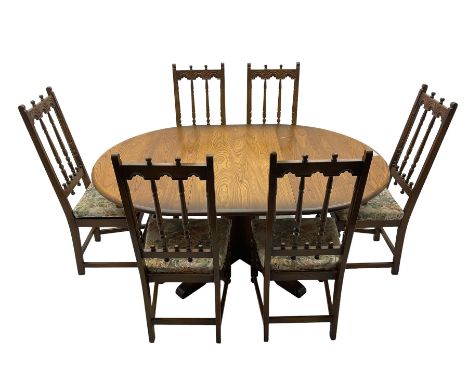 Ercol -elm and beech 'Chester' dining table, circular pull-out action extending top, on shaped cruciform pedestal with sledge