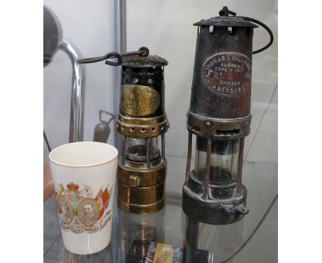 A Thomas and Williams miners lamp together with a smaller example, a commemorative beaker and a Richards signed poster and a 