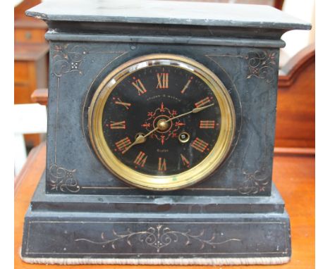 A black slate mantle clock, the circular dial with Roman numerals inscribed “Upjohn & Michie"