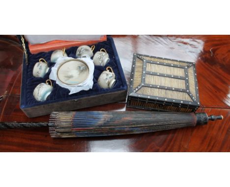 A Japanese porcelain tea set, cased, together with a porcupine quill jewellery box and a parasol