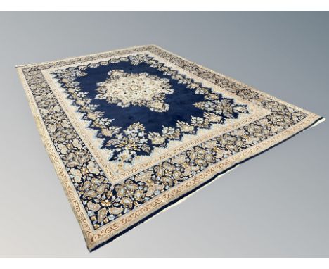 A Kirman carpet on blue ground, South East Iran, 293 cm x 410 cm 