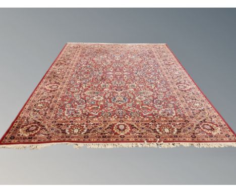 A machine made Persian style carpet on red ground, 431 cm x 300 cm 