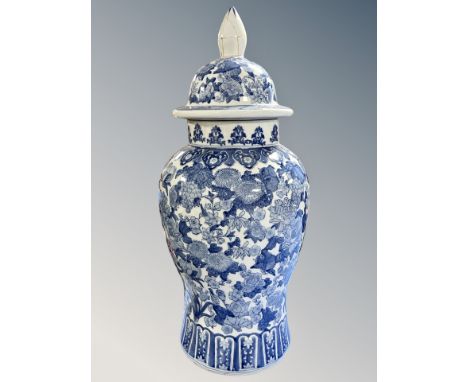 A large Chinese style porcelain blue and white lidded baluster vase, height 70 cm (a/f)  CONDITION REPORT: Finial restored. 