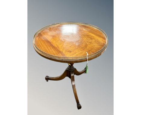 A mahogany tripod occasional table with brass gallery top, diameter 59 cm 