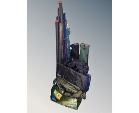 A group of fishing equipment including rods, folding chairs, landing net, bundle of garden tools 