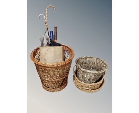 A group of wicker baskets, umbrellas, tennis rackets, framed print, together with several planters/pots 