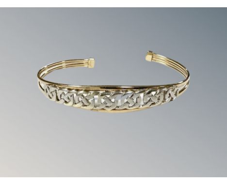 A 9ct two-tone gold bangle, 6.3g.