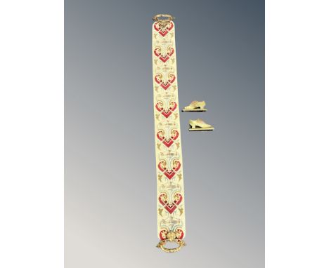An Ecclesiastical tapestry pull chord with ornate ormolu handles together with two brass fireplace shoe ornaments 