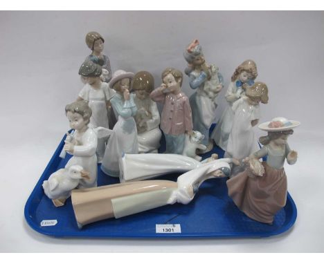 Nao Pottery Figurines, the tallest a Nun holding Rabbit 27cm high (13):- One Tray.One figure of girls holding dress with chip