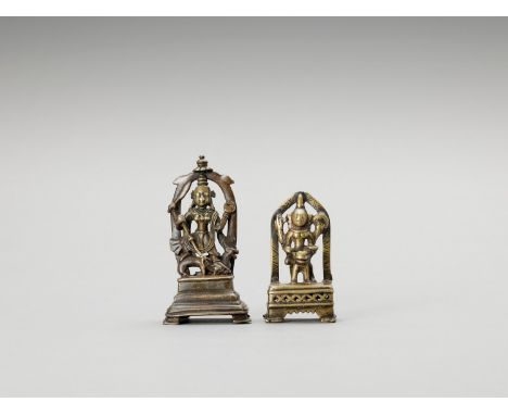   TWO INDIAN BRASS FIGURES OF SHIVA AND DURGA  India, 17th to 18th century. The larger piece depicting the four-armed Durga i