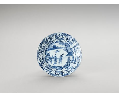   A LOBED BLUE AND WHITE PORCELAIN DISH  China, Kangxi period (1662-1722). Painted in underglaze blue, the show side with an 
