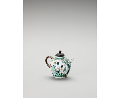  A FAMILLE VERTE TEAPOT AND COVER  China, Kangxi period (1662-1722). The baluster shaped, lobed teapot with metal and bamboo