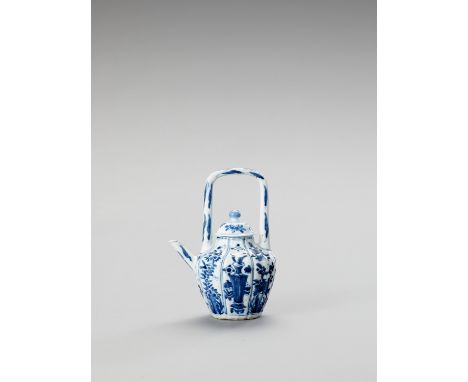   A BLUE AND WHITE PORCELAIN TEAPOT  China, Kangxi period (1662-1722). The baluster shaped, lobed teapot with high handle and